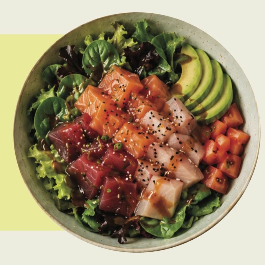 Green bowl with sashimi, avocado and greens
