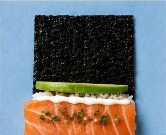 Salmon hand roll with avocado on a sheet of nori
