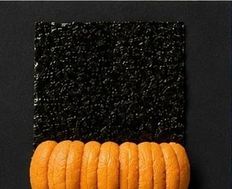 Hand roll with sea urchin on a sheet of nori
